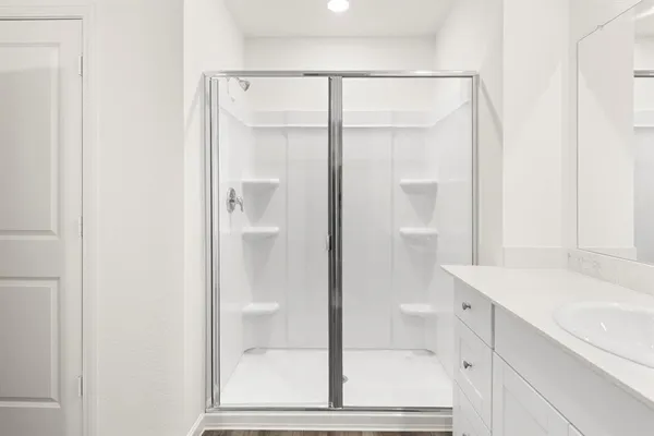 a bathroom with a double vanity sink and mirror