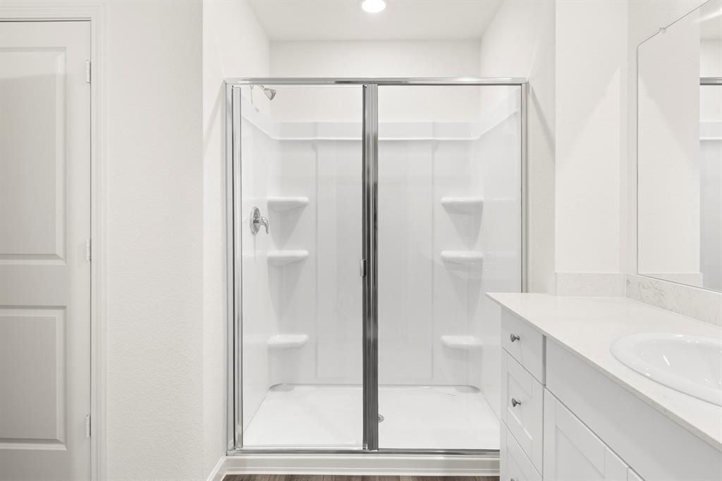 1444 Lake Alpine Trail Anna, TX 75409 - Photo 18 of 29 a bathroom with a shower sink and mirror