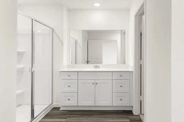 a bathroom with a double vanity sink and a mirror