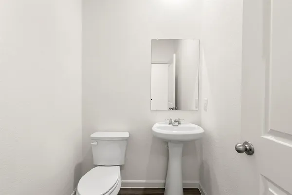 a bathroom with a sink mirror and toilet