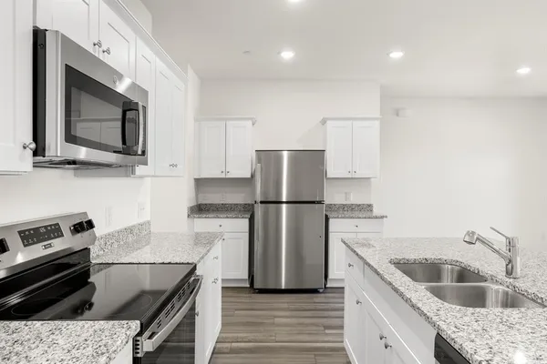 a kitchen with a sink stove and refrigerator