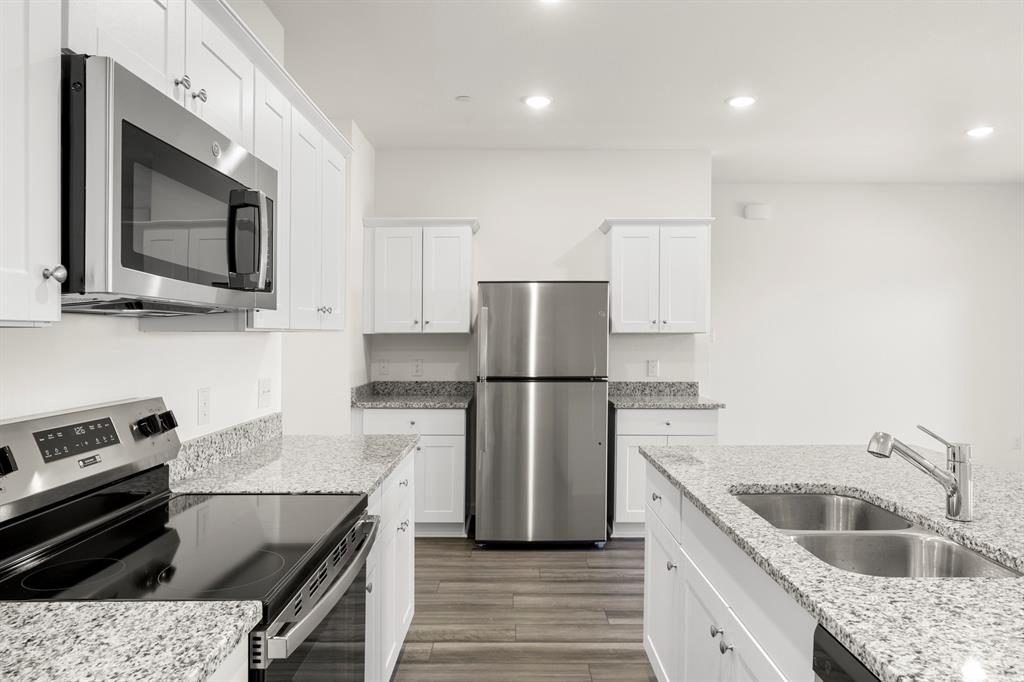1444 Lake Alpine Trail Anna, TX 75409 - Photo 10 of 29 a kitchen with a sink stove and refrigerator