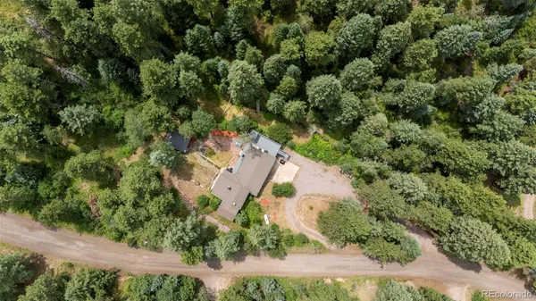 an aerial view of a house with yard