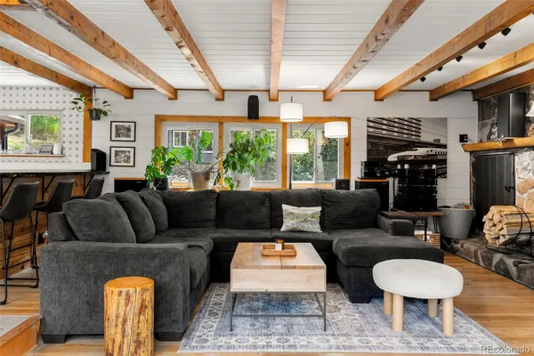 a living room with furniture a fireplace and a large window