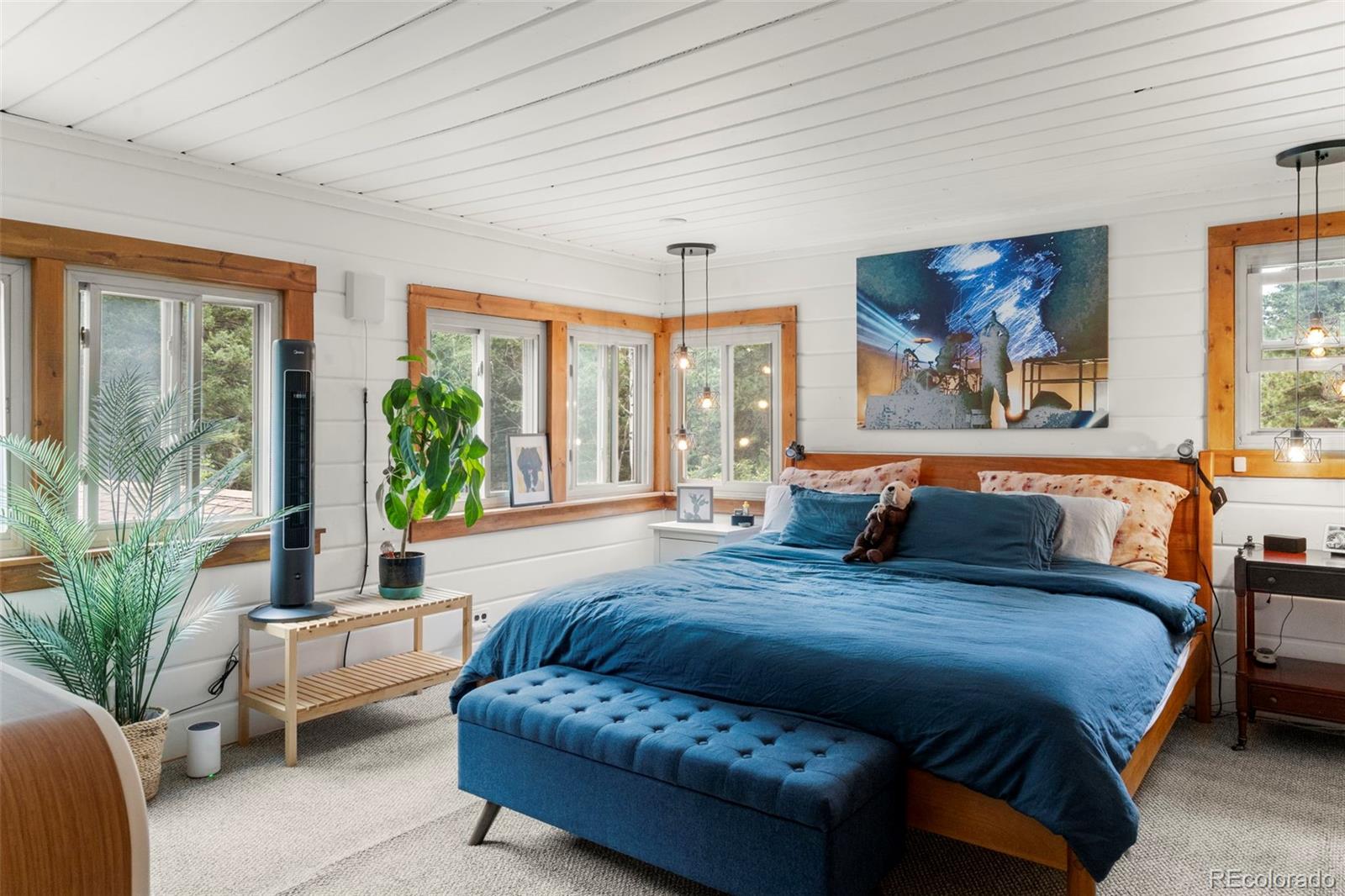 11933 South Maxwell Hill Road Littleton, CO 80127 - Photo 6 of 16 a spacious bedroom with a large bed couch and a large window