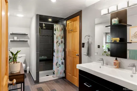 a bathroom with a double vanity sink and a mirror