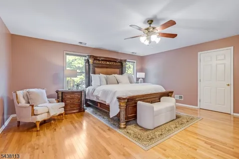 a bedroom with a bed and ceiling fan