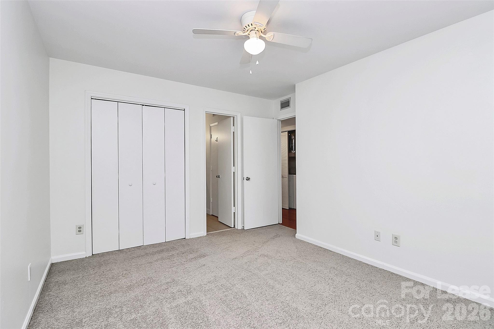 430 Queens Road, Unit 711 Charlotte, NC 28204 - Photo 16 of 20 an empty room with a ceiling fan and a window