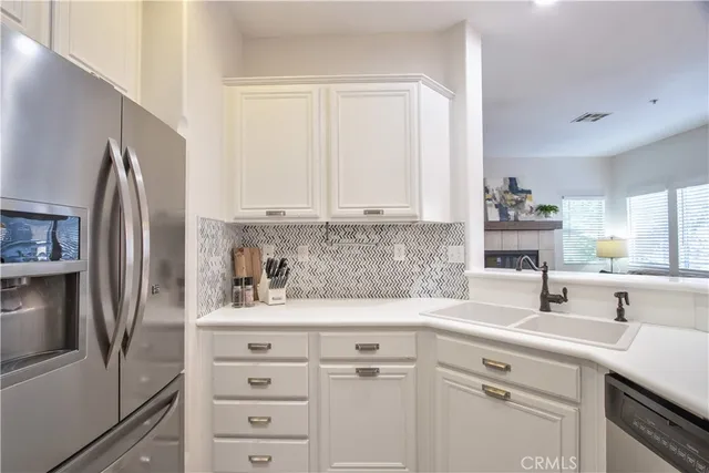 a kitchen with stainless steel appliances a sink stove and cabinets