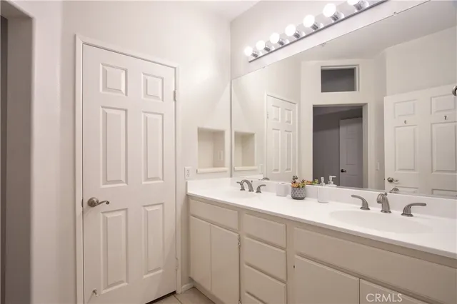 a white toilet sitting next to a white wall