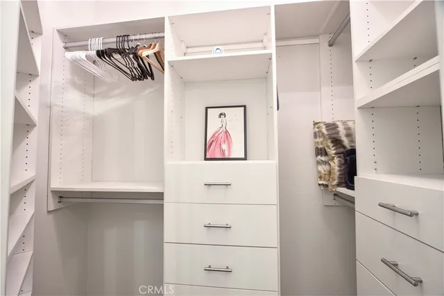 a spacious bedroom with a bed and a window