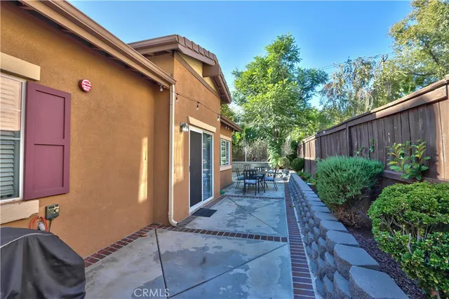 a view of a wooden dinning table and chairs in patio