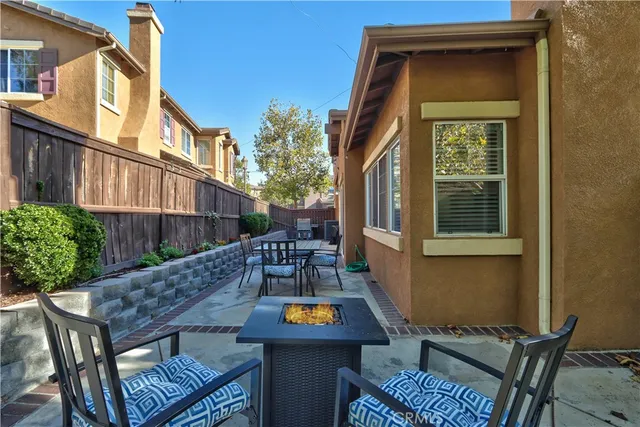 a view of a patio with table and chairs and potted plants