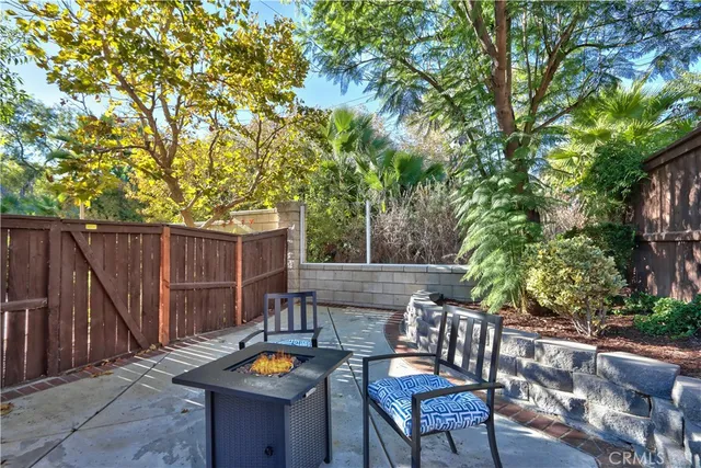 a view of swimming pool with outdoor seating and house in the background