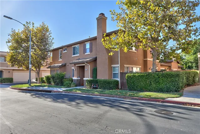 a view of a hallway with wooden floor and a potted plant
