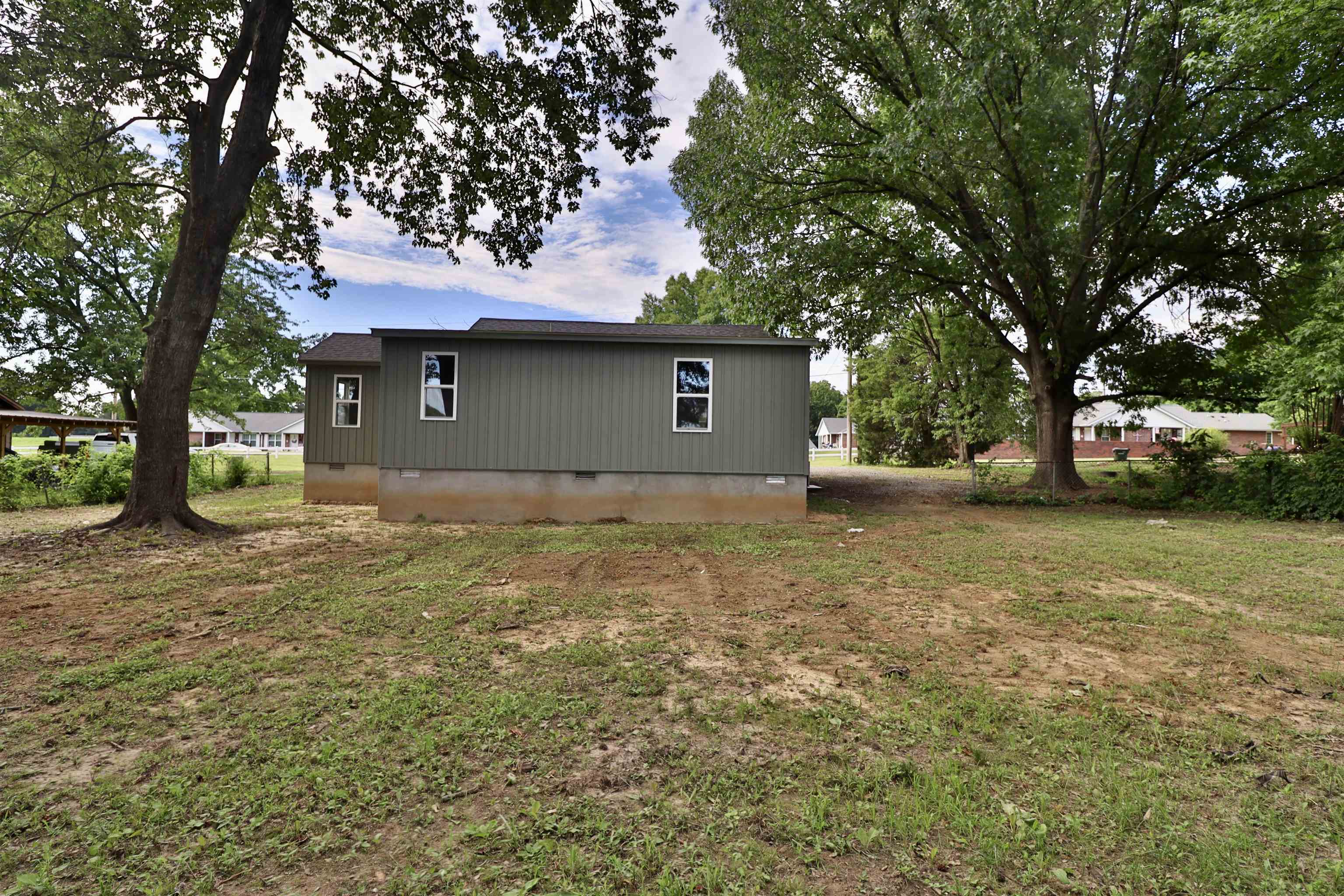 224 Kellar Avenue Ripley, TN 38063 - Photo 31 of 35 a backyard of a house with lots of green space