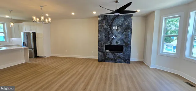 a view of a livingroom with furniture window wooden floor and a chandelier