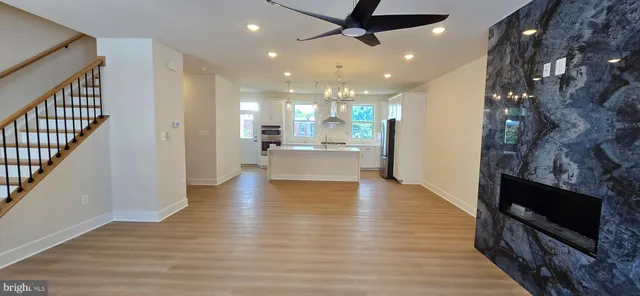 a view of a living room a flat screen tv with kitchen view