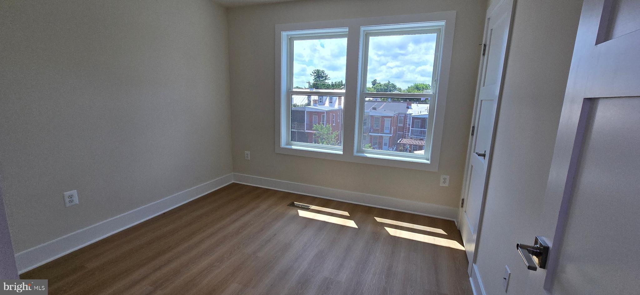 414 Chapel Alley, Unit 2 Frederick, MD 21701 - Photo 19 of 41 a view of an empty room with wooden floor and a window