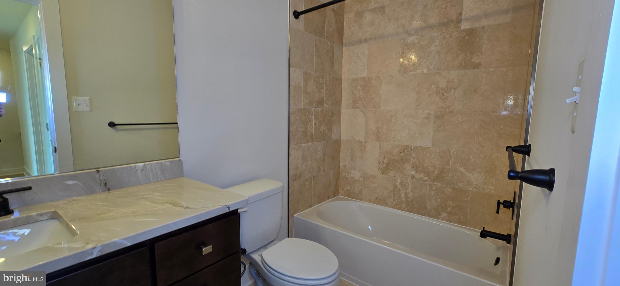 414 Chapel Alley, Unit 2 Frederick, MD 21701 - Photo 30 of 41 a bathroom with a granite countertop sink toilet and shower