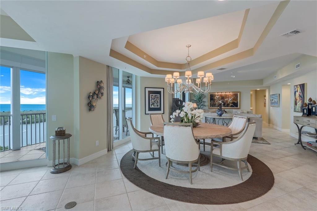 295 Grande Way, Unit 1202 Naples, FL 34110 - Photo 12 of 36 a view of a dining room with furniture