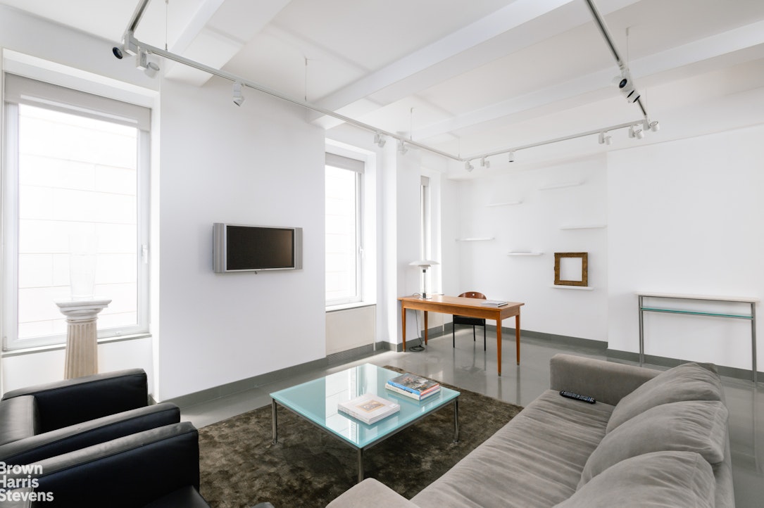 1000 Park Avenue, Unit 7F Manhattan, NY 10028 - Photo 2 of 7 a living room with furniture and a wooden floor