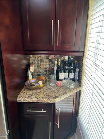 a kitchen with granite countertop stainless steel appliances and wooden cabinets