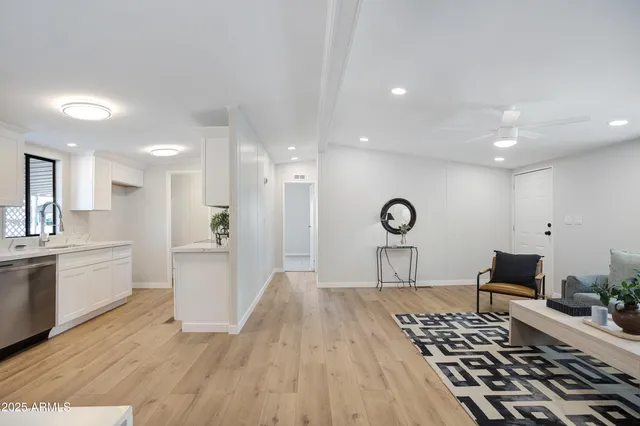 a open kitchen with white cabinets and stainless steel appliances