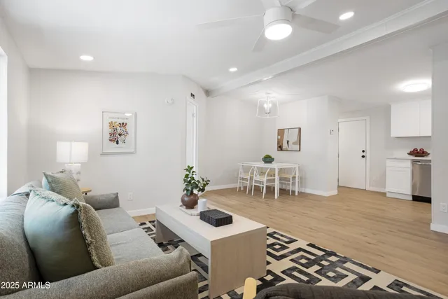 a living room with furniture and wooden floor