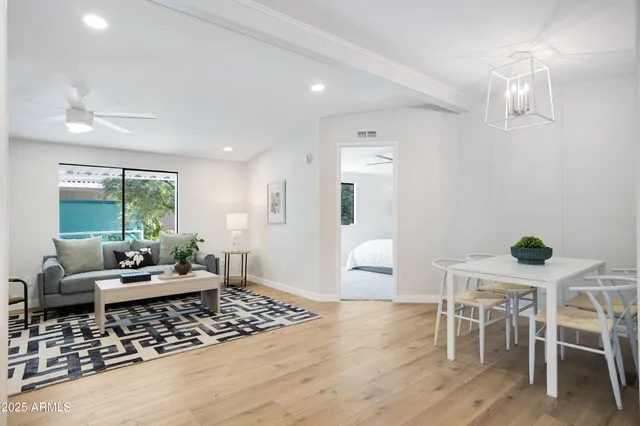 a living room with furniture and wooden floor