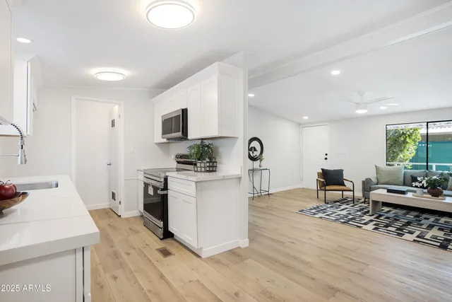 a living room with furniture appliances and wooden floor