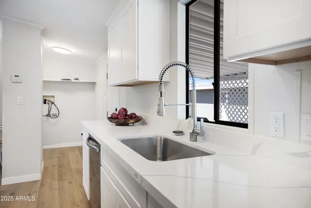 a kitchen with a sink and cabinets