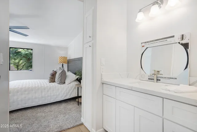 a bedroom with a bed and a mirror