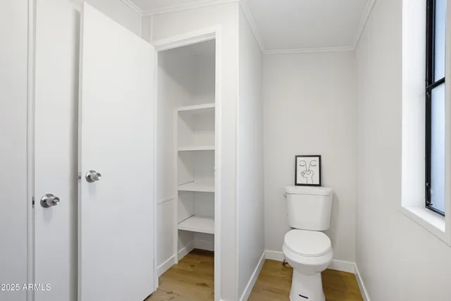 a a bathroom view of a toilet and a sink