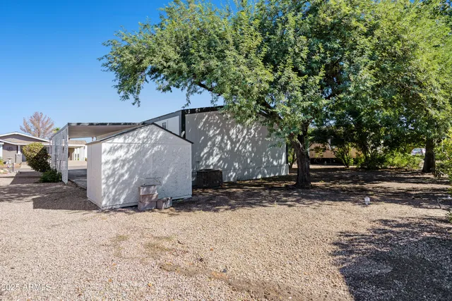 a view of a backyard with large trees