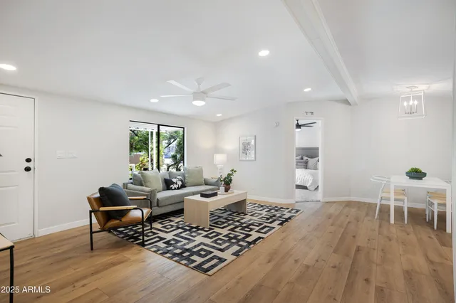a living room with furniture and wooden floor