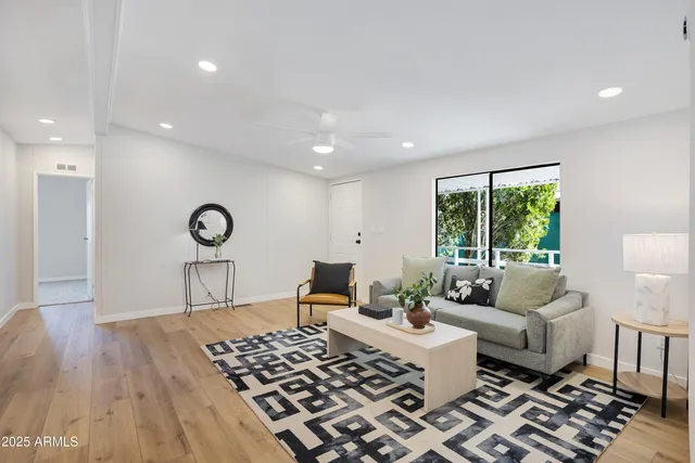 a living room with a couch and a table with wooden floor