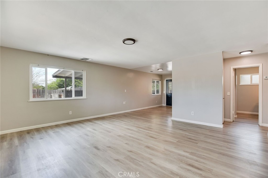 582 Wesley Street Banning, CA 92220 - Photo 15 of 49 a view of an empty room with wooden floor and a window