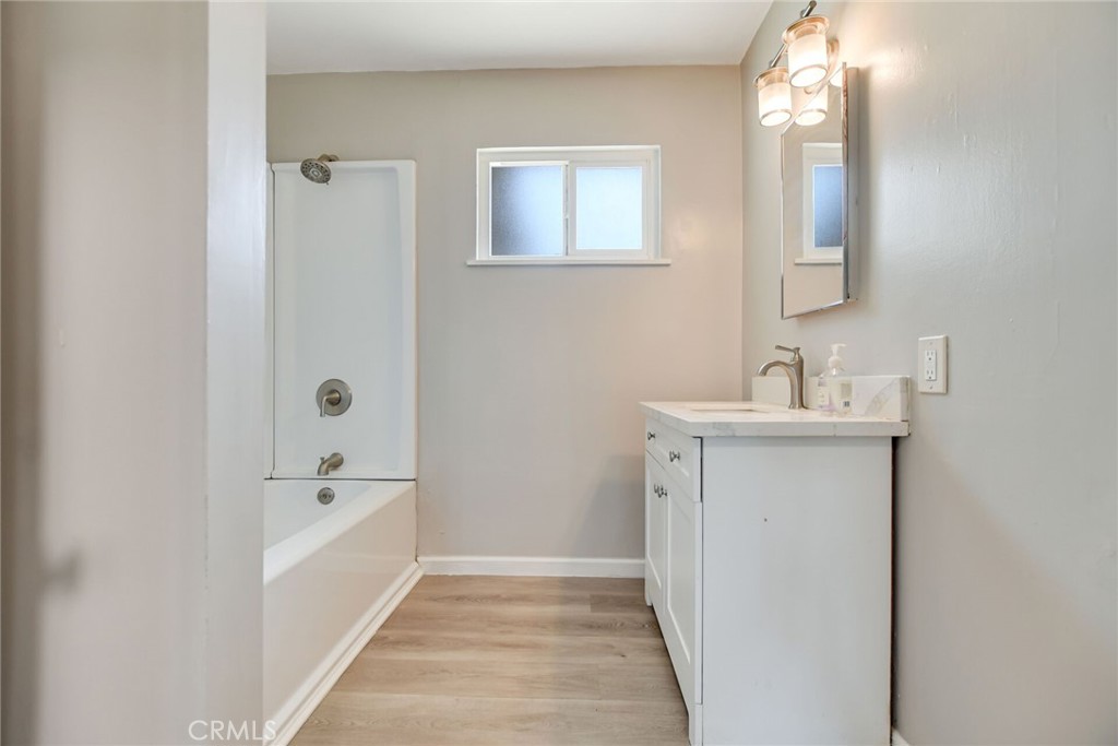 582 Wesley Street Banning, CA 92220 - Photo 24 of 49 a bathroom with a sink a mirror and a bathtub