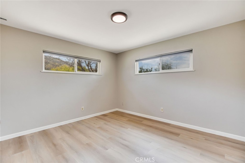 582 Wesley Street Banning, CA 92220 - Photo 25 of 49 a view of an empty room with wooden floor