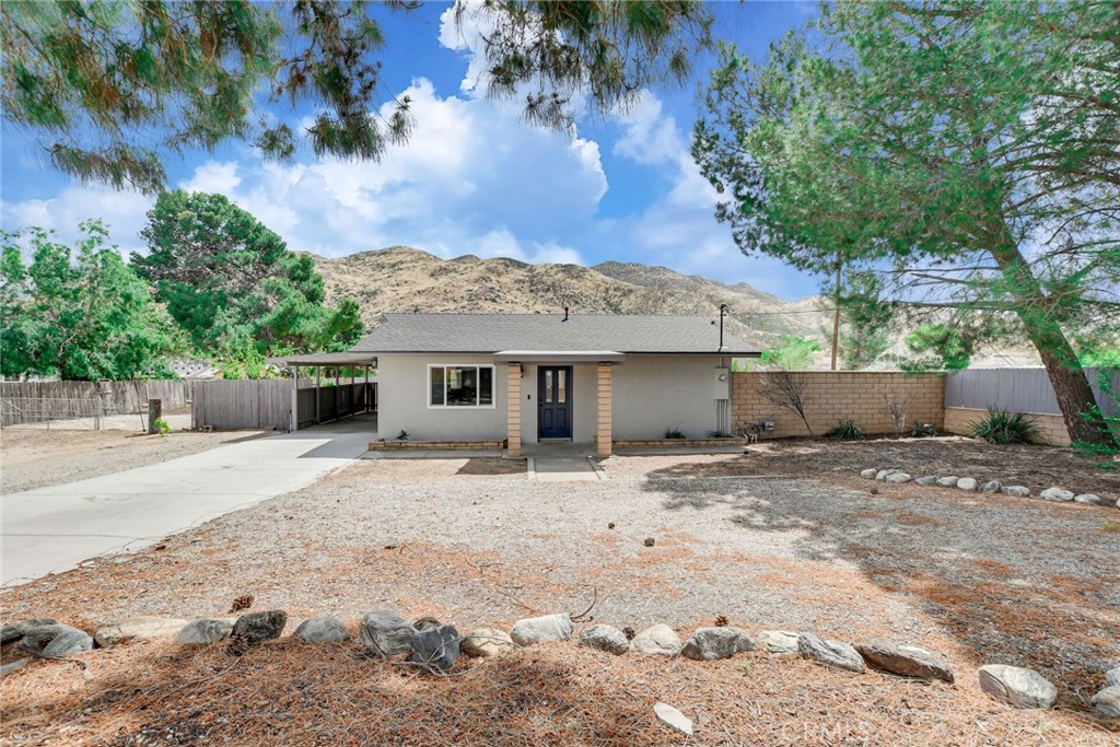 582 Wesley Street Banning, CA 92220 - Photo 5 of 49 a front view of a house with a yard
