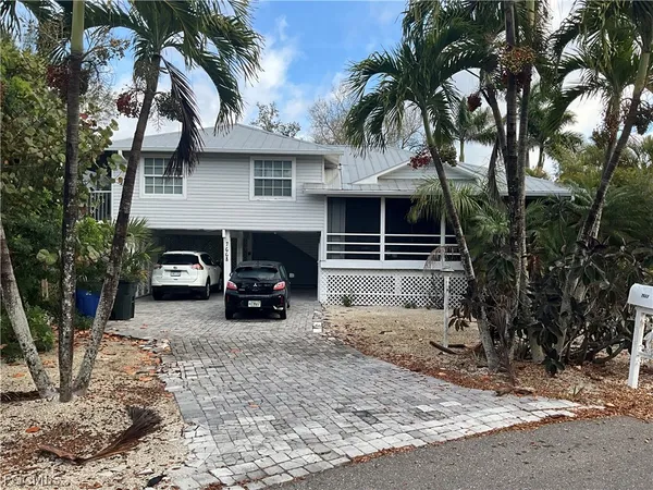 a view of house with outdoor space and trees