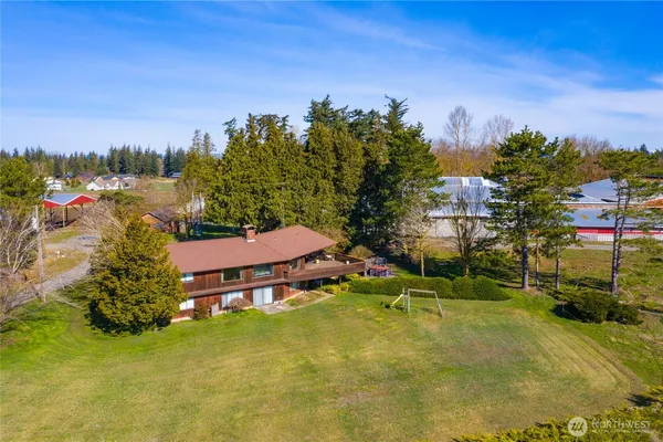 an aerial view of a house with swimming pool and deck