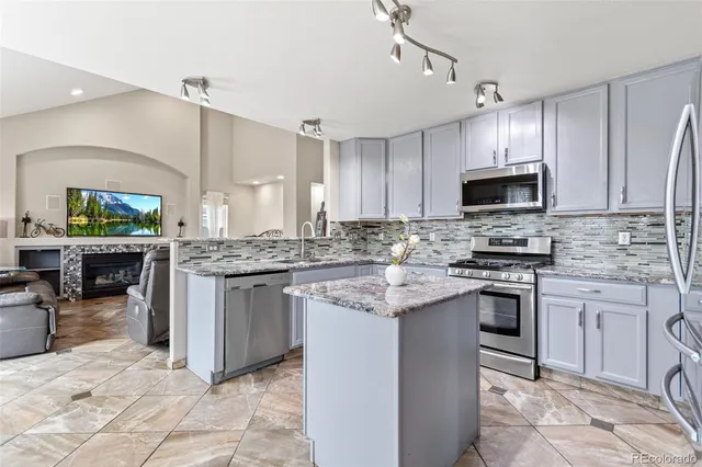 an empty room with windows and ceiling fan