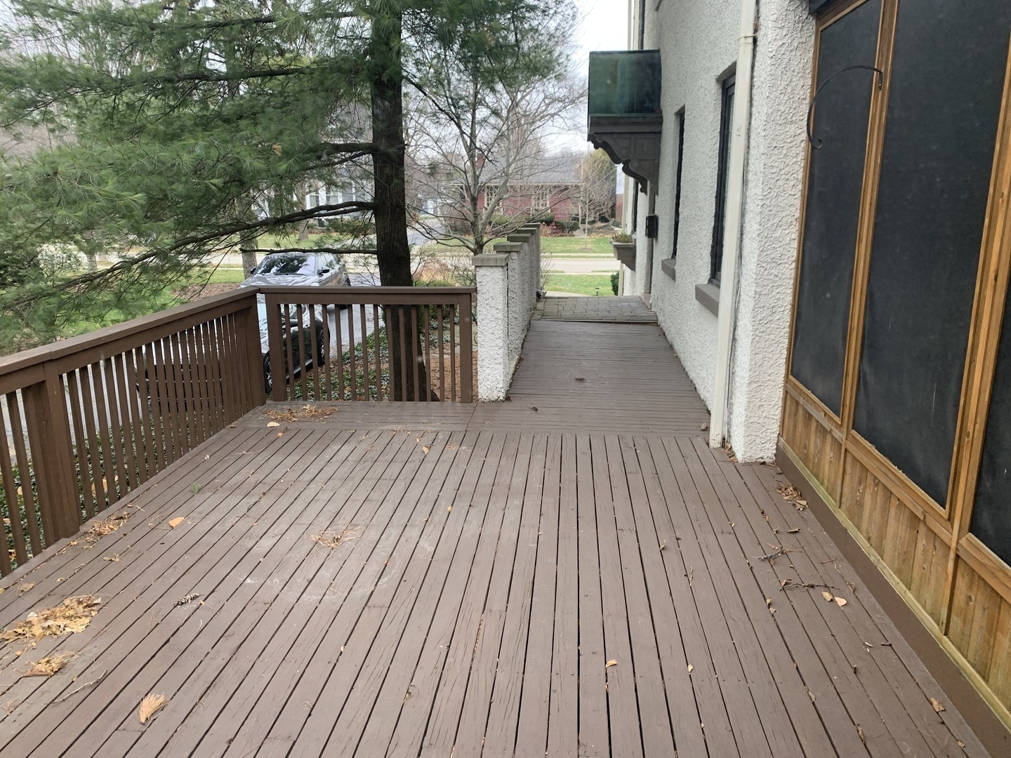 205 Herrick Road Riverside, IL 60546 - Photo 16 of 28 a balcony with wooden floor and yard in the back