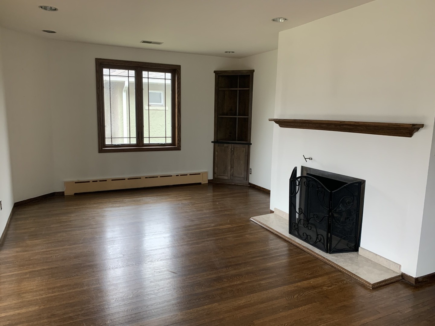 205 Herrick Road Riverside, IL 60546 - Photo 5 of 28 an empty room with wooden floor and fireplace