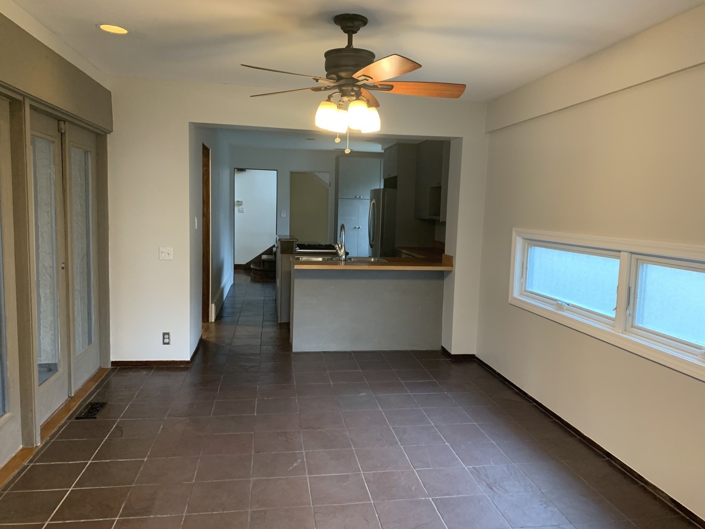 205 Herrick Road Riverside, IL 60546 - Photo 9 of 28 a view of a living room with a chandelier fan and windows