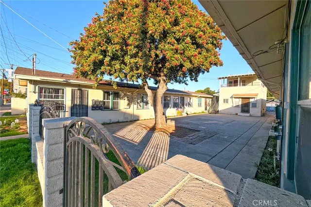 a view of a house with backyard and sitting area