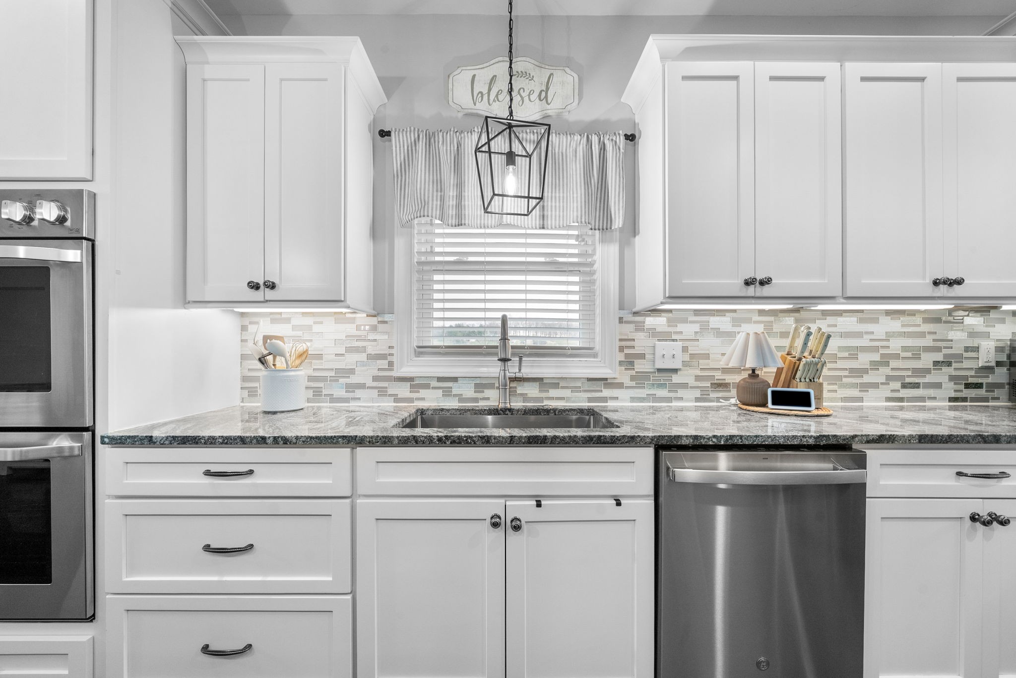 3021 7 Mile Ferry Road Clarksville, TN 37040 - Photo 25 of 99 a kitchen with granite countertop white cabinets and stainless steel appliances