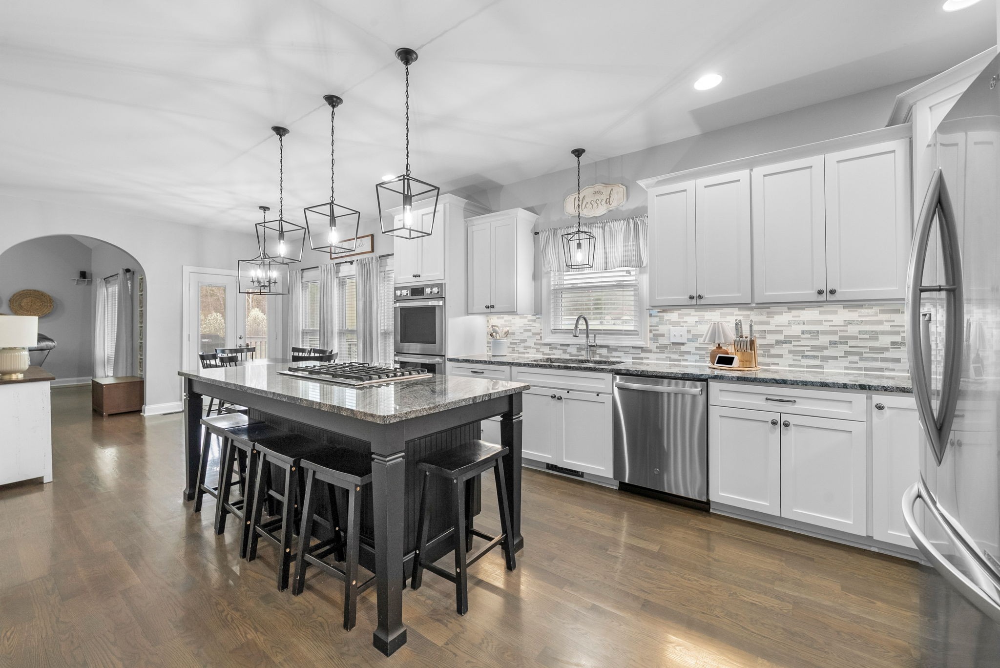 3021 7 Mile Ferry Road Clarksville, TN 37040 - Photo 28 of 99 a kitchen with kitchen island granite countertop a sink a center island and stainless steel appliances
